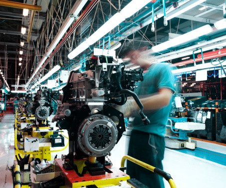 workman manufacturing in a car factory